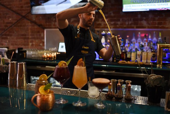Warike Restobar bar with bartender making drinks.