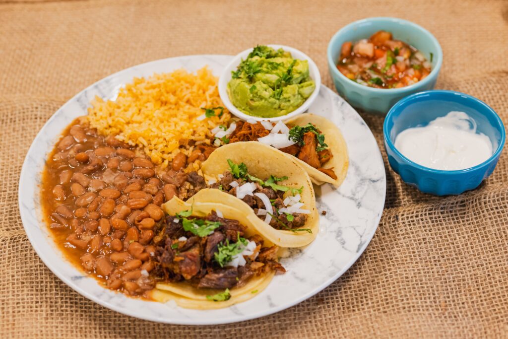 Two tacos, rice, and beans.
